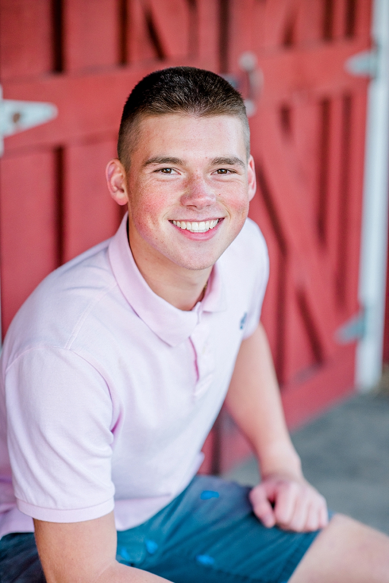 senior photo with boy in pink shirt